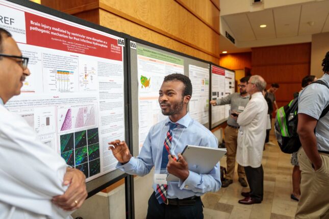 Medical student Ayodamola Otun discusses his summer research with Amit Mathur, MD